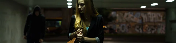man stalking woman in a parking garage